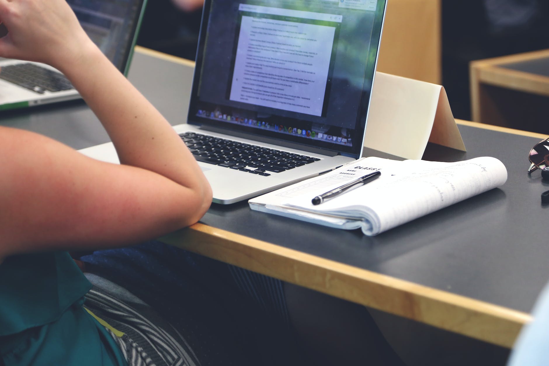 person sitting in front of the laptop computer